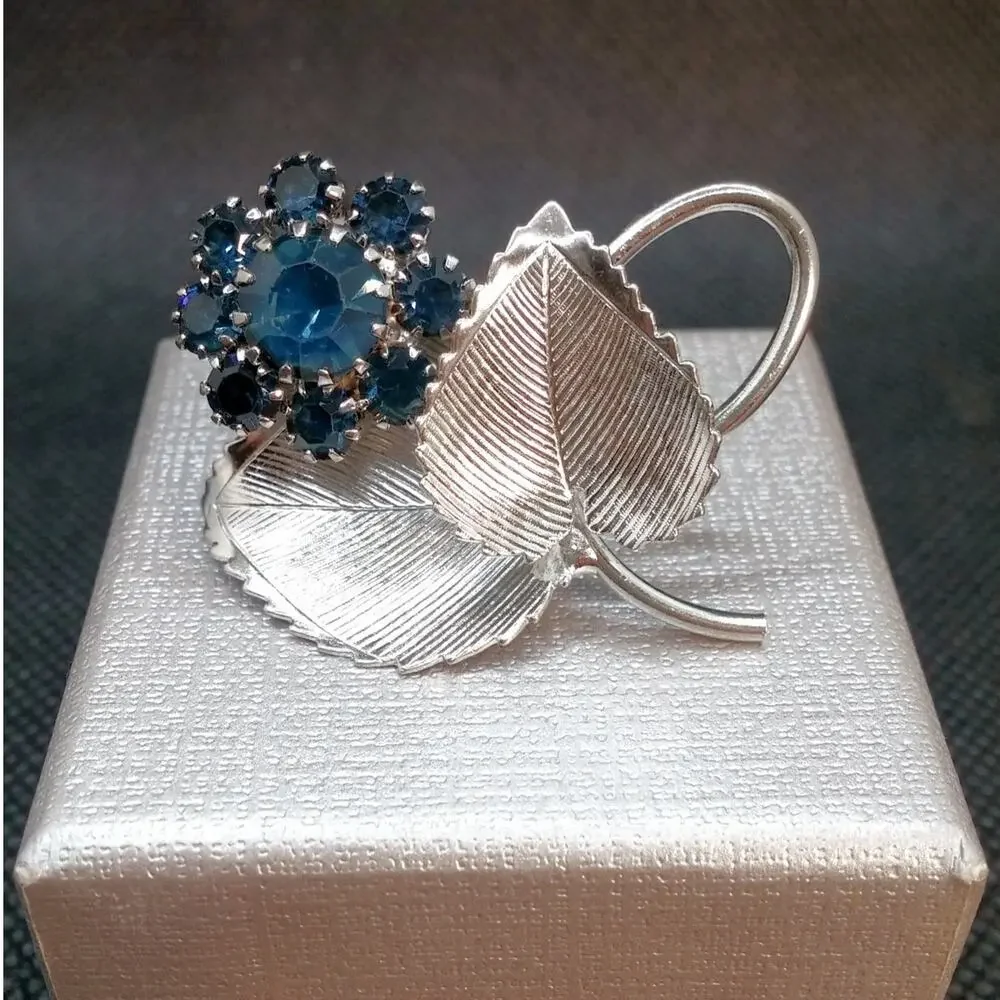 Vintage Silver Tone Flower Brooch Blue Rhinestones Prong Setting Textured Leaves